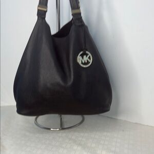 The image shows a Michael Kors Colgate Reversible Grab Bag in black.